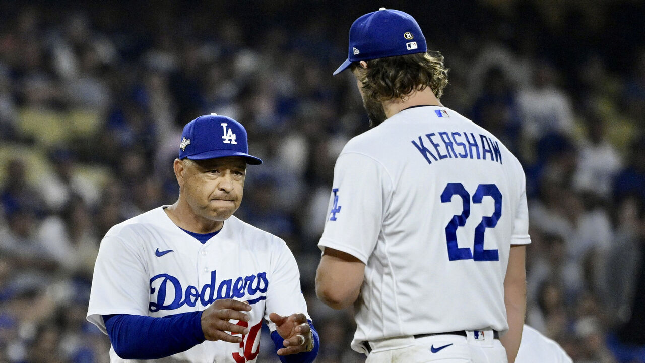Los Angeles, CA - October 07: Manager Dave Robert #30 takes starting pitcher Clayton Kershaw #22 of the Los Angeles Dodgers after giving up 6 runs to the Arizona Diamondbacks in the first inning during Game 1 of a National League Division Series baseball game at Dodger Stadium in Los Angeles on Saturday, October 7, 2023.