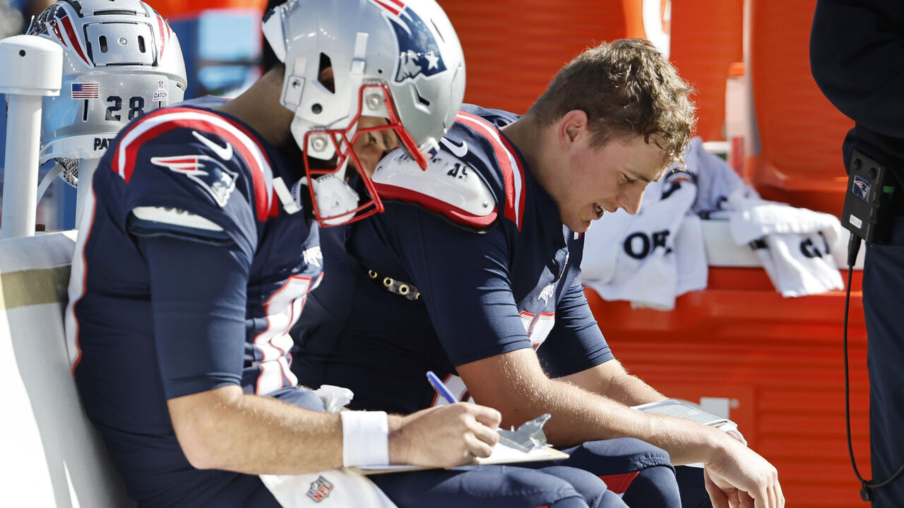 FOXBOROUGH, MASSACHUSETTS - OCTOBER 08: Mac Jones #10 of the New England Patriots reacts while sitting on the bench during the second quarter against the New Orleans Saints at Gillette Stadium on October 08, 2023 in Foxborough, Massachusetts.