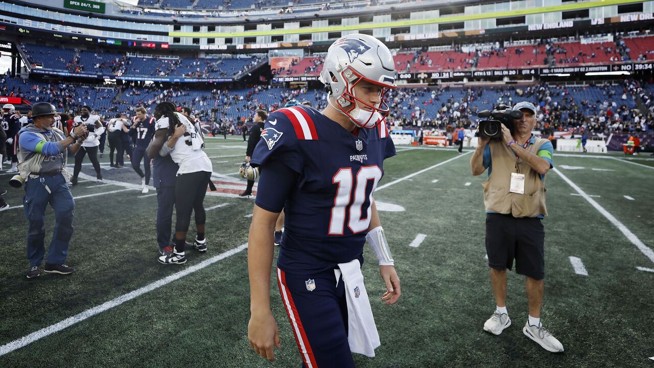 FOXBOROUGH, MASSACHUSETTS - OCTOBER 08: Mac Jones #10 of the New England Patriots walks off the field after his team's 34-0 loss against the New Orleans Saints at Gillette Stadium on October 08, 2023 in Foxborough, Massachusetts.