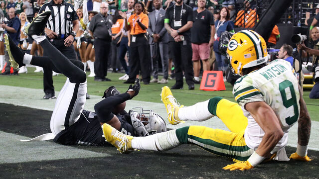 LAS VEGAS, NEVADA - OCTOBER 09: Amik Robertson #21 of the Las Vegas Raiders intercepts a pass intended for Christian Watson #9 of the Green Bay Packers during the fourth quarter at Allegiant Stadium on October 09, 2023 in Las Vegas, Nevada.