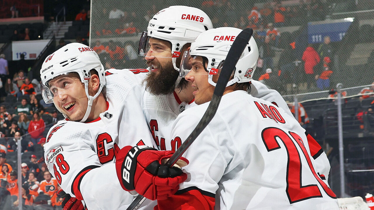 PHILADELPHIA, PENNSYLVANIA - OCTOBER 29: Brent Burns #8 of the Carolina Hurricanes celebrates his game-winning overtime goal against the Philadelphia Flyers with Martin Necas #88 and Sebastian Aho #20 at the Wells Fargo Center on October 29, 2022 in Philadelphia, Pennsylvania. The Hurricanes defeated the Flyers 4-3.