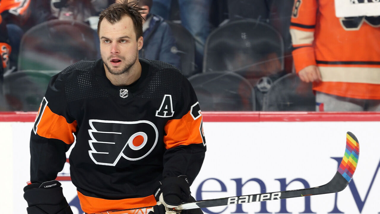 PHILADELPHIA, PA - FEBRUARY 21: Scott Laughton #21 of the Philadelphia Flyers skates during warm-ups prior to his game against the Carolina Hurricanes at the Wells Fargo Center on February 21, 2022 in Philadelphia, Pennsylvania. The Flyers are using rainbow taped sticks during warm-ups in honor of Pride Night.
