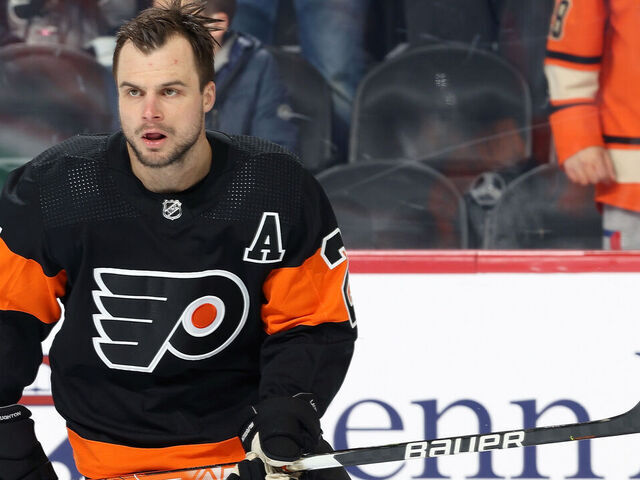 PHILADELPHIA, PA - FEBRUARY 21: Scott Laughton #21 of the Philadelphia Flyers skates during warm-ups prior to his game against the Carolina Hurricanes at the Wells Fargo Center on February 21, 2022 in Philadelphia, Pennsylvania. The Flyers are using rainbow taped sticks during warm-ups in honor of Pride Night.