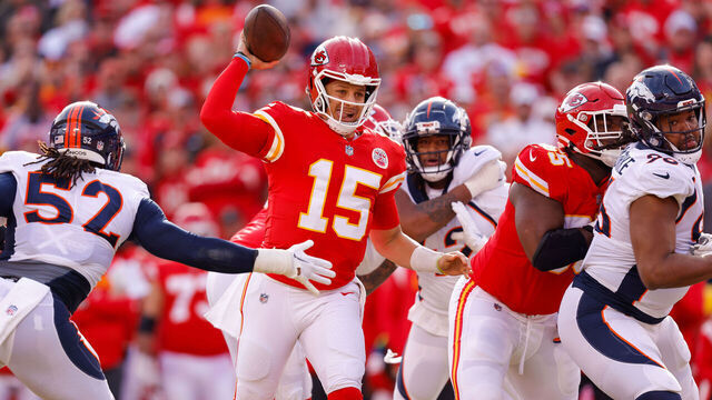 KANSAS CITY, MO - JANUARY 01: Patrick Mahomes #15 of the Kansas City Chiefs throws a pass under pressure from Wyatt Ray #52 of the Denver Broncos during the second quarter at Arrowhead Stadium on January 1, 2023 in Kansas City, Missouri.