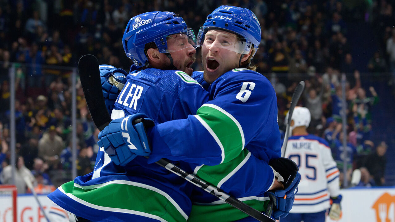 VANCOUVER, CANADA - OCTOBER 11: Brock Boeser #6 is congratulated by J.T. Miller #9 of the Vancouver Canucks after scoring a goal during the first period of their NHL game against the Edmonton Oilers at Rogers Arena on October 11, 2023 in Vancouver, British Columbia, Canada.
