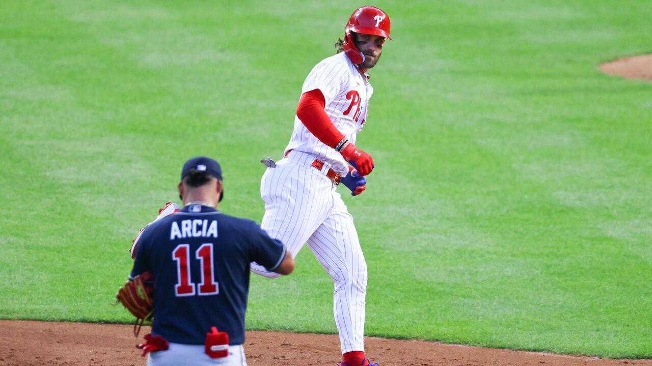 PHILADELPHIA, PA - OCTOBER 11: Bryce Harper #3 of the Philadelphia Phillies rounds second base ant stares down Orlando Arcia #11 of the Atlanta Braves during Game 3 of the NLDS on October 11, 2023 at Citizens Bank Park in Philadelphia, Pennsylvania.