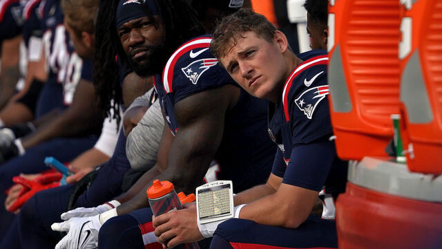 Foxborough, MA - October 8: New England Patriots QB Mac Jones sits on the bench in the fourth quarter. The Patriots lost to the New Orleans Saints, 34-0.