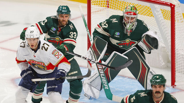 SAINT PAUL, MN - OCTOBER 12: Alex Goligoski #33 and Filip Gustavsson #32 of the Minnesota Wild defend against Eetu Luostarinen #27 of the Florida Panthers during the game at the Xcel Energy Center on October 12, 2023 in Saint Paul, Minnesota.