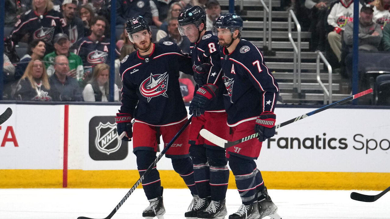 COLUMBUS, OHIO - OCTOBER 12: Jack Roslovic #96 of the Columbus Blue Jackets and Sean Kuraly #7 of the Columbus Blue Jackets help Zach Werenski #8 of the Columbus Blue Jackets off the ice during the second period against the Philadelphia Flyers at Nationwide Arena on October 12, 2023 in Columbus, Ohio.