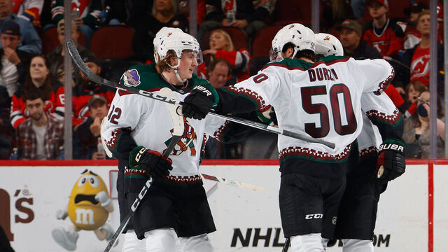 NEWARK, NEW JERSEY - OCTOBER 13: Logan Cooley #92 and Sean Durzi #50 of the Arizona Coyotes celebrate Durzi's second period goal against the New Jersey Devils at Prudential Center on October 13, 2023 in Newark, New Jersey.