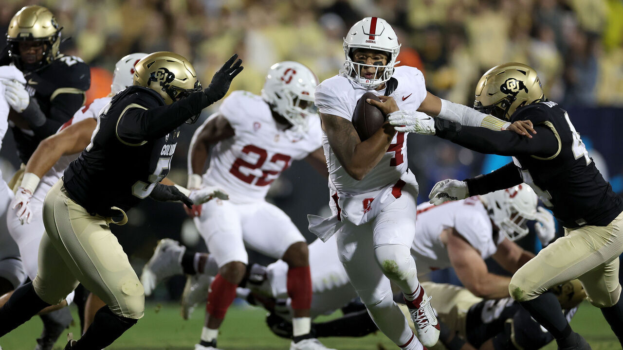 BOULDER, COLORADO - OCTOBER 13: Quarterback Ashton Daniels #14 of the Stanford Cardinal runs with the ball against Jordan Domineck #44 of the Colorado Buffaloes in the second quarter at Folsom Field on October 13, 2023 in Boulder, Colorado.
