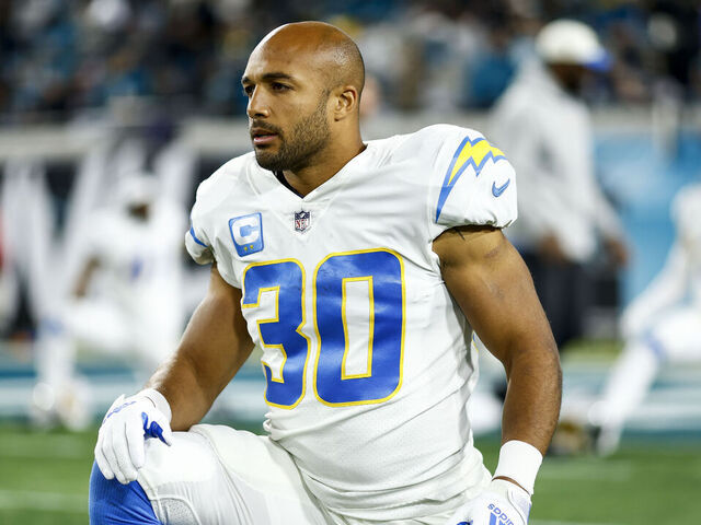 JACKSONVILLE, FL - JANUARY 14: Austin Ekeler #30 of the Los Angeles Chargers stretches prior to an NFL wild card playoff football game against the Jacksonville Jaguars at TIAA Bank Field on January 14, 2023 in Jacksonville, Florida.