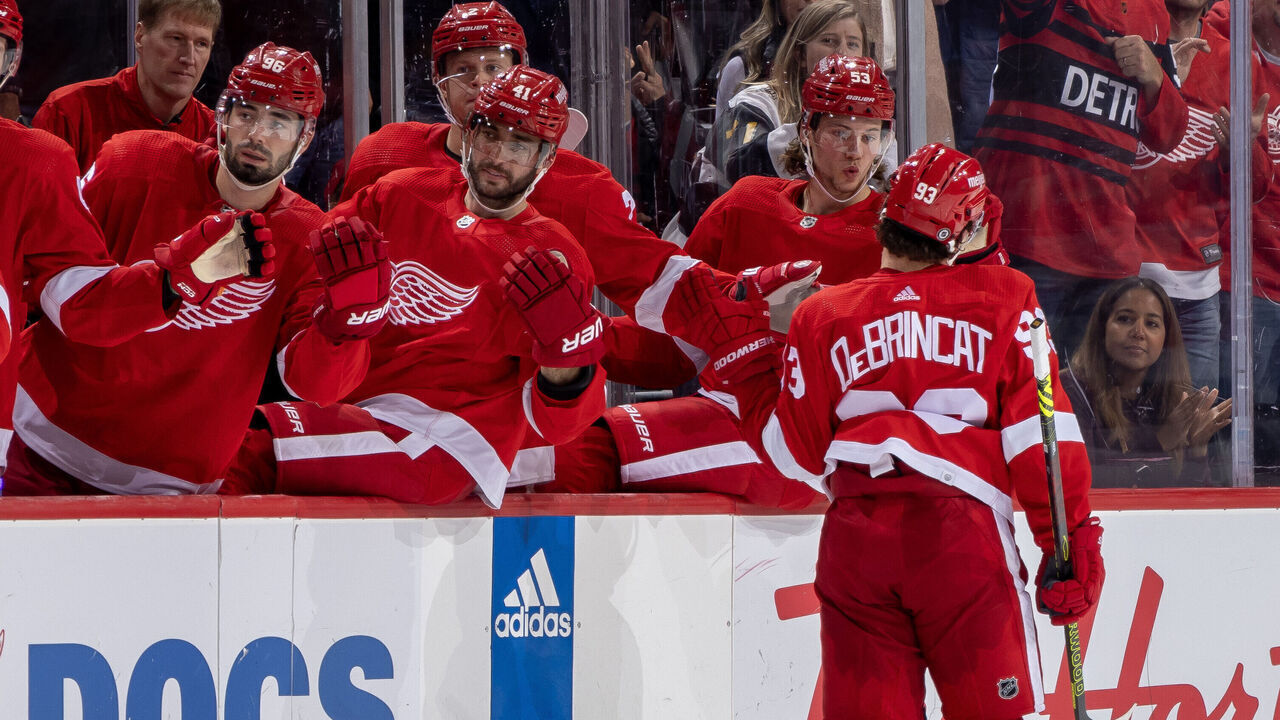 DETROIT, MI - OCTOBER 14: Alex DeBrincat #93 of the Detroit Red Wings celebrates his goal against the Tampa Bay Lightning with teammates on the bench in the third period of the home opener at Little Caesars Arena on October 14, 2023 in Detroit, Michigan. Detroit defeated Tampa Bay 6-4.