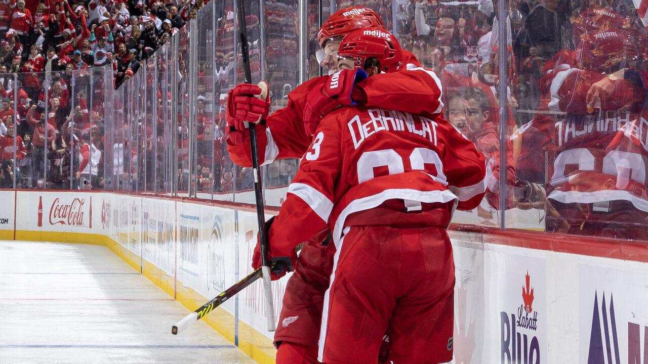 DETROIT, MI - OCTOBER 14: Alex DeBrincat #93 of the Detroit Red Wings celebrates his goal against the Tampa Bay Lightning with teammate Lucas Raymond #23 of the Detroit Red Wings in the third period of the home opener at Little Caesars Arena on October 14, 2023 in Detroit, Michigan. Detroit defeated Tampa Bay 6-4.