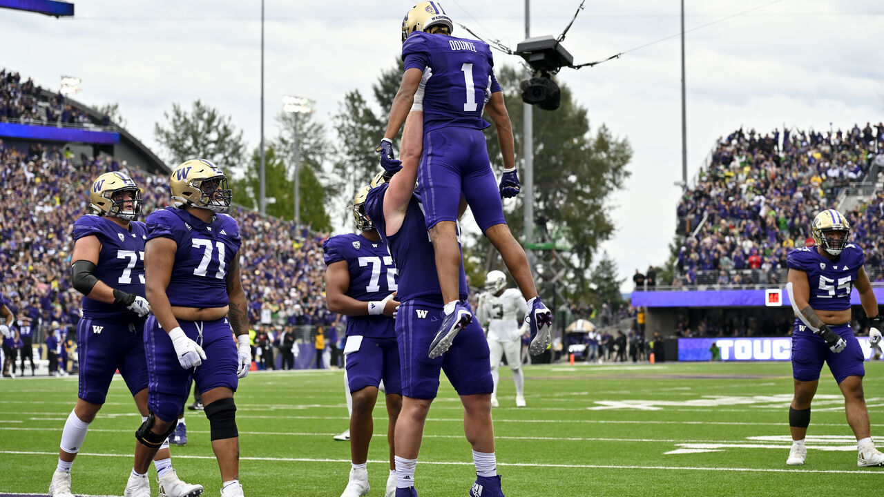 SEATTLE, WASHINGTON - OCTOBER 14: Rome Odunze #1 of the Washington Huskies celebrates with teammates after scoring a touchdown during the third quarter against the Oregon Ducks at Husky Stadium on October 14, 2023 in Seattle, Washington. The Washington Huskies won 36-33.