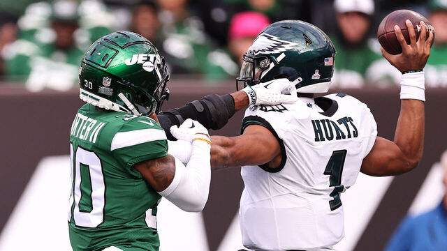 EAST RUTHERFORD, NEW JERSEY - OCTOBER 15: Jalen Hurts #1 of the Philadelphia Eagles throws a pass while under pressure from Michael Carter II #30 of the New York Jets during the first half at MetLife Stadium on October 15, 2023 in East Rutherford, New Jersey.