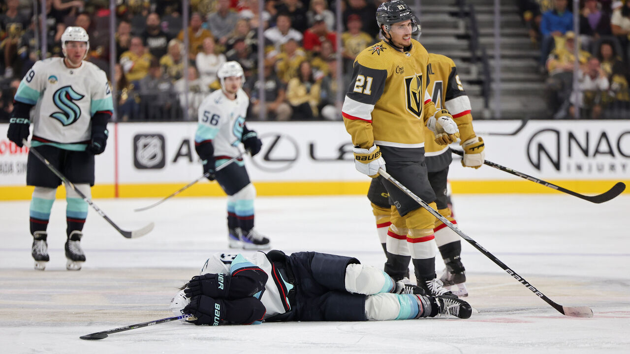 LAS VEGAS, NEVADA - OCTOBER 10: Brandon Tanev #13 of the Seattle Kraken lies on the ice after taking an illegal check to the head from Brett Howden #21 of the Vegas Golden Knights in the third period of their game at T-Mobile Arena on October 10, 2023 in Las Vegas, Nevada. Howden received a match penalty for the hit. The Golden Knights defeated the Kraken 4-1.