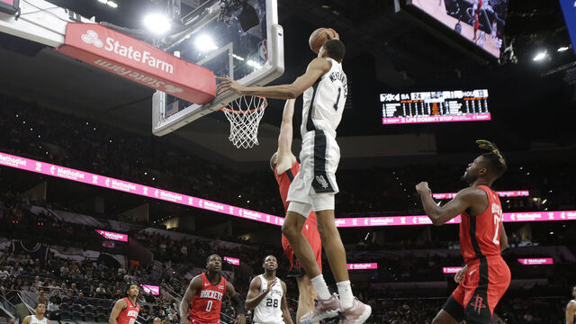 SAN ANTONIO, TX - OCTOBER 18: Victor Wembanyama #1 of the San Antonio Spurs drives over Jock Landale #2 of the Houston Rockets in the first half of a pre-season NBA game at Frost Bank Center on October 18, 2023 in San Antonio, Texas. NOTE TO USER: User expressly acknowledges and agrees that, by downloading and or using this photograph, User is consenting to terms and conditions of the Getty Images License Agreement.