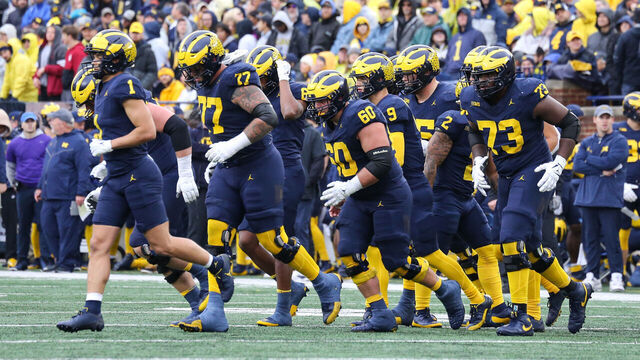 ANN ARBOR, MI - OCTOBER 14: The Michigan offensive players jog to the ball after a timeout during the second quarter of a Big Ten Conference college football game between the Indiana Hoosiers and the Michigan Wolverines on October 14, 2023 at Michigan Stadium in Ann Arbor, Michigan.