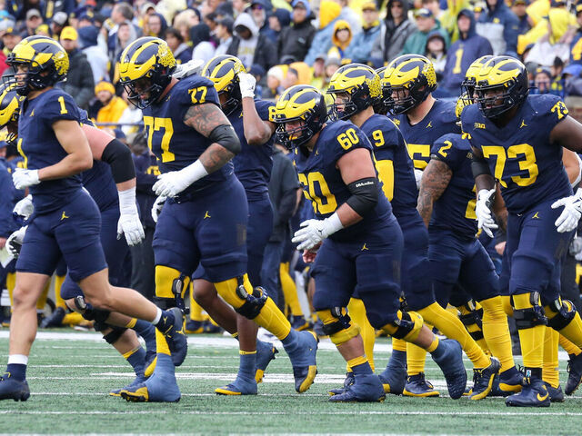 ANN ARBOR, MI - OCTOBER 14: The Michigan offensive players jog to the ball after a timeout during the second quarter of a Big Ten Conference college football game between the Indiana Hoosiers and the Michigan Wolverines on October 14, 2023 at Michigan Stadium in Ann Arbor, Michigan.