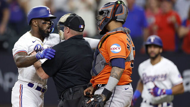 ARLINGTON, TEXAS - OCTOBER 20: Adolis Garcia #53 of the Texas Rangers argues with Martin Maldonado #15 of the Houston Astros after being hit by a pitch by Bryan Abreu #52 of the Houston Astros during the eighth inning in Game Five of the American League Championship Series at Globe Life Field on October 20, 2023 in Arlington, Texas.