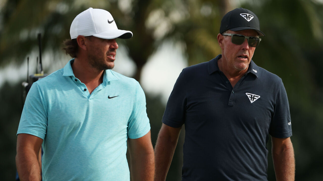 DORAL, FLORIDA - OCTOBER 20: Captain Phil Mickelson of HyFlyers GC and Captain Brooks Koepka of Smash GCwalk together after Koepka defeated Mickelson 6&4 during Day One of the LIV Golf Invitational - Miami at Trump National Doral Miami on October 20, 2023 in Doral, Florida.