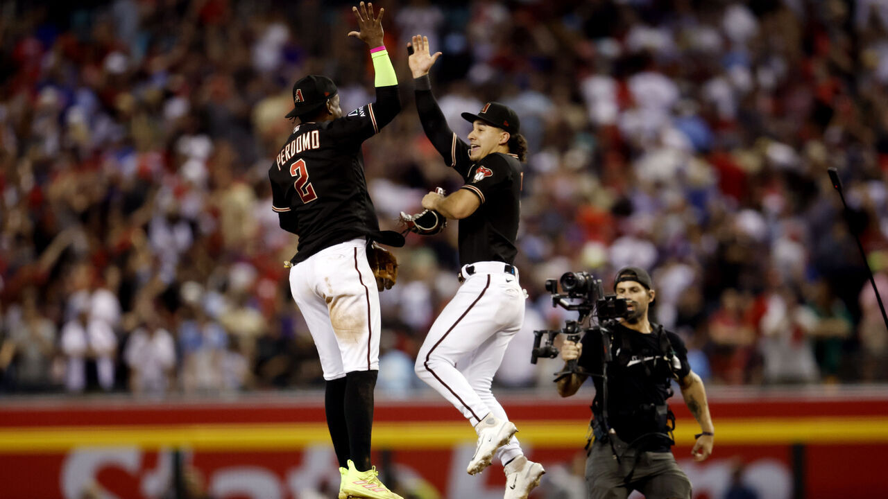 PHOENIX, AZ - OCTOBER 20: Geraldo Perdomo #2 and Alek Thomas #5 of the Arizona Diamondbacks celebrate after the Diamondbacks defeated the Philadelphia Phillies in Game 4 of the NLCS at Chase Field on Friday, October 20, 2023 in Phoenix, Arizona.