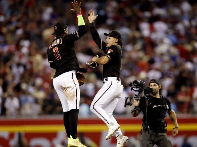 PHOENIX, AZ - OCTOBER 20: Geraldo Perdomo #2 and Alek Thomas #5 of the Arizona Diamondbacks celebrate after the Diamondbacks defeated the Philadelphia Phillies in Game 4 of the NLCS at Chase Field on Friday, October 20, 2023 in Phoenix, Arizona.