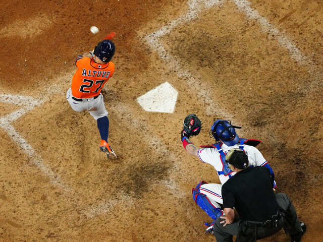 ARLINGTON, TX - OCTOBER 20: Jose Altuve #27 of the Houston Astros hits a three-run home run to retake the lead in the ninth inning during Game 5 of the ALCS between the Houston Astros and the Texas Rangers at Globe Life Field on Friday, October 20, 2023 in Arlington, Texas.