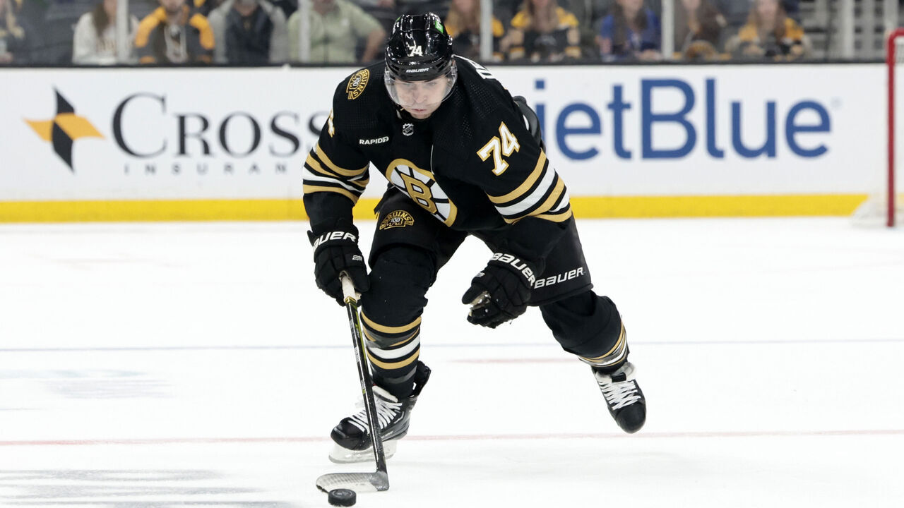 BOSTON, MA - SEPTEMBER 24: Boston Bruins left wing Jake DeBrusk (74) picks up the puck during a game between the Boston Bruins and the New York Rangers on September 24, 2023, at TD Garden in Boston, Massachusetts.