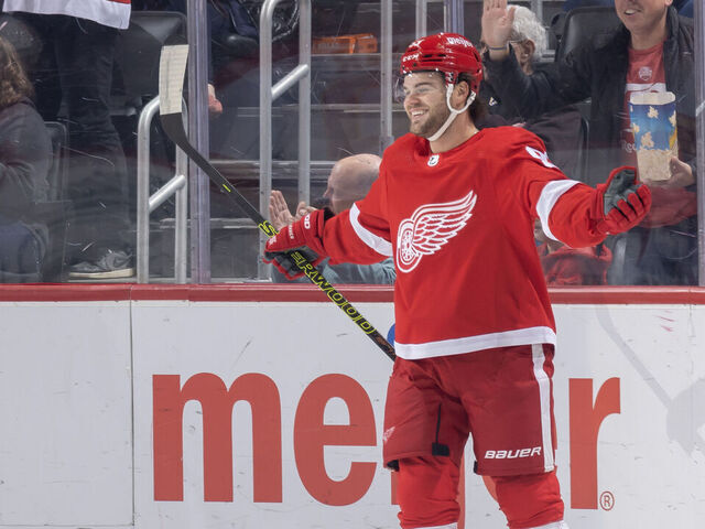 DETROIT, MI - OCTOBER 22: Alex DeBrincat #93 of the Detroit Red Wings celebrates a goal against the Calgary Flames during the first period at Little Caesars Arena on October 22, 2023 in Detroit, Michigan.