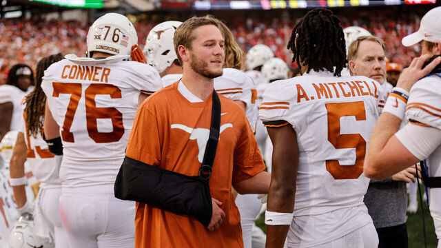 HOUSTON, TEXAS - OCTOBER 21: Quinn Ewers #3 of the Texas Longhorns wears a sling while congratulating Adonai Mitchell #5 after a touchdown in the second half against the Houston Cougars at TDECU Stadium on October 21, 2023 in Houston, Texas.