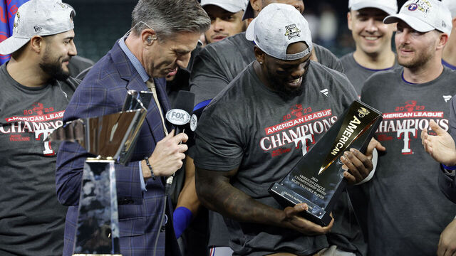 HOUSTON, TEXAS - OCTOBER 23: Adolis Garcia #53 of the Texas Rangers celebrates with the ALCS MVP Trophy after defeating the Houston Astros in Game Seven to win the American League Championship Series at Minute Maid Park on October 23, 2023 in Houston, Texas.