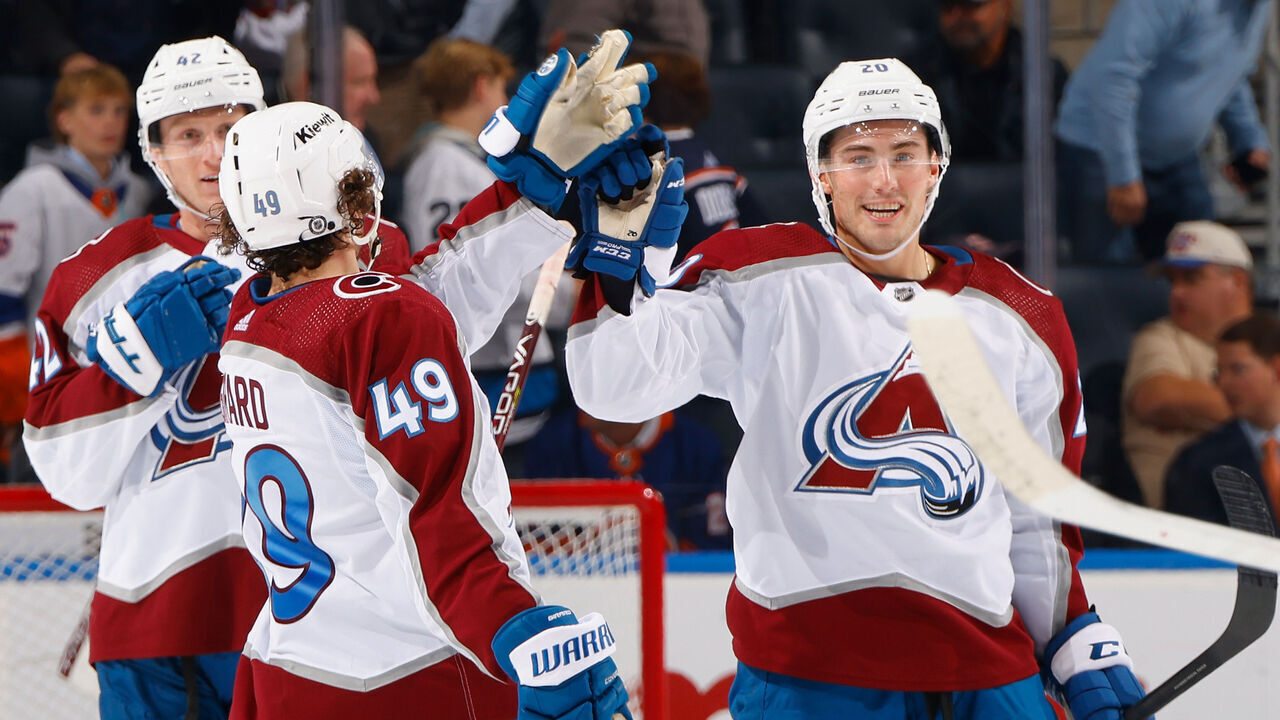 ELMONT, NEW YORK - OCTOBER 24: Ross Colton #20 of the Colorado Avalanche (R) celebrates his empty net goal against the New York Islanders at UBS Arena on October 24, 2023 in Elmont, New York. The Avalanche defeated the Islanders 7-4.