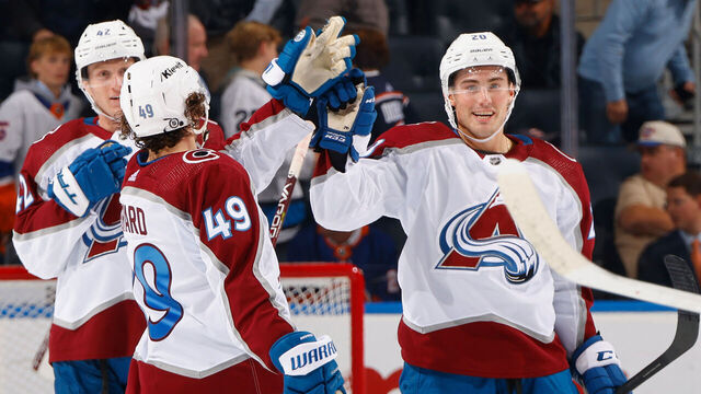 ELMONT, NEW YORK - OCTOBER 24: Ross Colton #20 of the Colorado Avalanche (R) celebrates his empty net goal against the New York Islanders at UBS Arena on October 24, 2023 in Elmont, New York. The Avalanche defeated the Islanders 7-4.