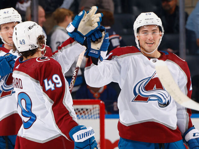 ELMONT, NEW YORK - OCTOBER 24: Ross Colton #20 of the Colorado Avalanche (R) celebrates his empty net goal against the New York Islanders at UBS Arena on October 24, 2023 in Elmont, New York. The Avalanche defeated the Islanders 7-4.