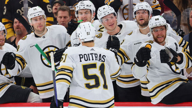 CHICAGO, ILLINOIS - OCTOBER 24: Matthew Poitras #51 of the Boston Bruins fist bumps teammates after scoring a goal against the Chicago Blackhawks during the third period at the United Center on October 24, 2023 in Chicago, Illinois.