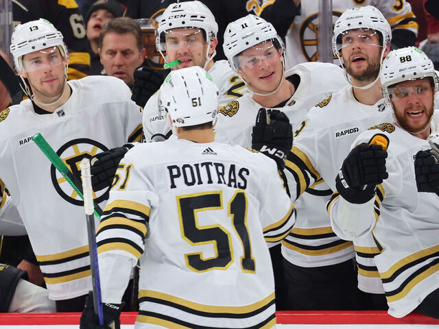 CHICAGO, ILLINOIS - OCTOBER 24: Matthew Poitras #51 of the Boston Bruins fist bumps teammates after scoring a goal against the Chicago Blackhawks during the third period at the United Center on October 24, 2023 in Chicago, Illinois.