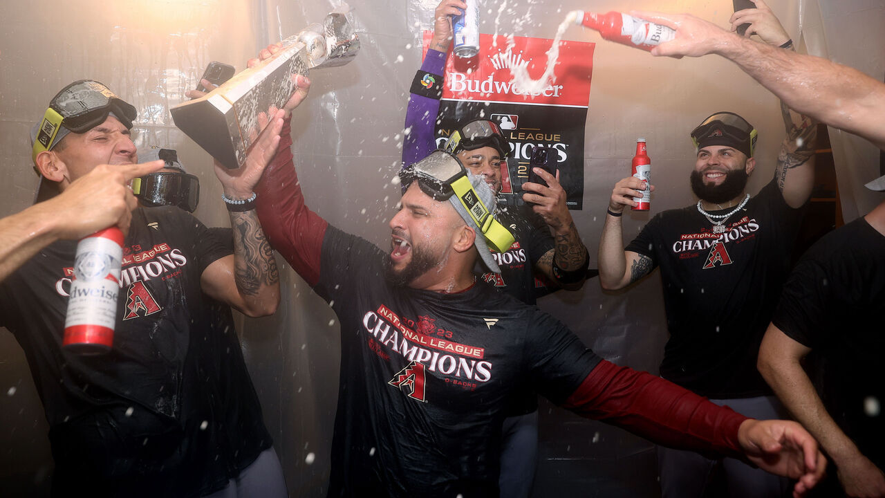PHILADELPHIA, PENNSYLVANIA - OCTOBER 24: Jose Herrera #11 of the Arizona Diamondbacks celebrates in the clubhouse after beating the Philadelphia Phillies in Game Seven of the Championship Series at Citizens Bank Park on October 24, 2023 in Philadelphia, Pennsylvania.