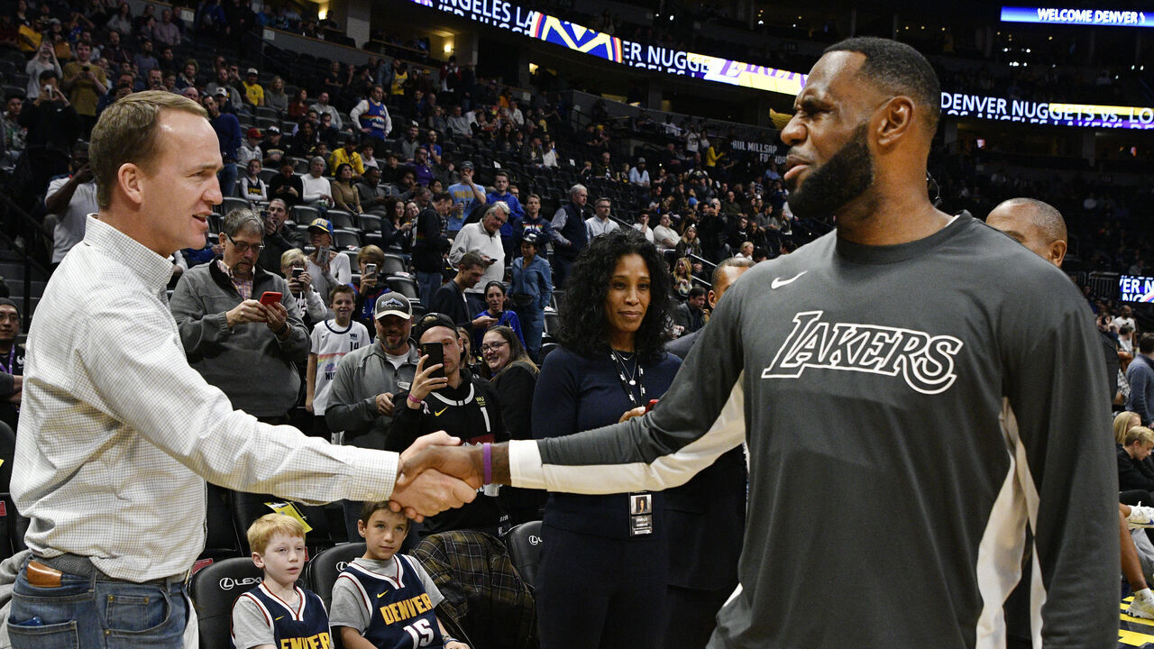 DENVER, CO - DECEMBER 03: Former Denver Broncos QB Peyton Manning, left, greets LeBron James (23) of the Los Angeles Lakers before the game against the Denver Nuggets at the Pepsi Center December 03, 2019.