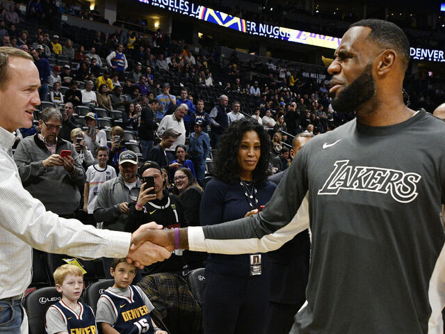 DENVER, CO - DECEMBER 03: Former Denver Broncos QB Peyton Manning, left, greets LeBron James (23) of the Los Angeles Lakers before the game against the Denver Nuggets at the Pepsi Center December 03, 2019.
