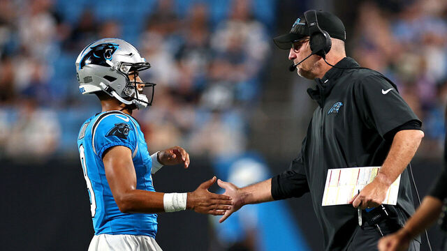 CHARLOTTE, NORTH CAROLINA - AUGUST 25: Bryce Young #9 and head coach Frank Reich of the Carolina Panthers slap hands during the first quarter of a preseason game against the Detroit Lions at Bank of America Stadium on August 25, 2023 in Charlotte, North Carolina.