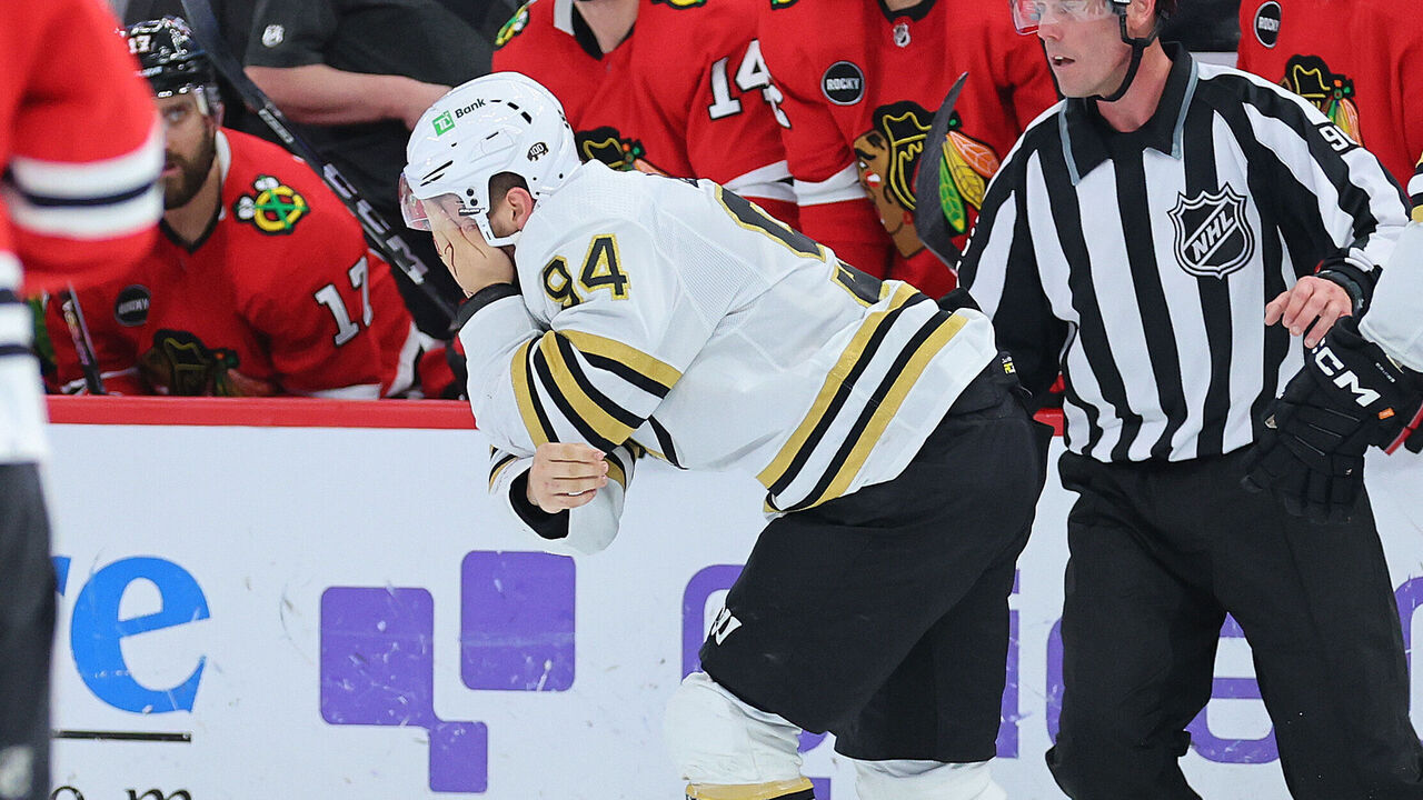 CHICAGO, ILLINOIS - OCTOBER 24: Jakub Lauko #94 of the Boston Bruins reacts after being hit in the eye with a skate by Jason Dickinson #16 of the Chicago Blackhawks (not pictured) during the third period at the United Center on October 24, 2023 in Chicago, Illinois.