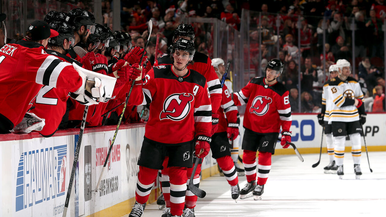 NEWARK, NEW JERSEY - DECEMBER 23: Jack Hughes #86 of the New Jersey Devils is congratulated by teammates after scoring during the 1st period of the game against the Boston Bruins at Prudential Center on December 23, 2022 in Newark, New Jersey.
