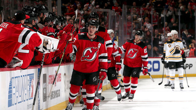 NEWARK, NEW JERSEY - DECEMBER 23: Jack Hughes #86 of the New Jersey Devils is congratulated by teammates after scoring during the 1st period of the game against the Boston Bruins at Prudential Center on December 23, 2022 in Newark, New Jersey.