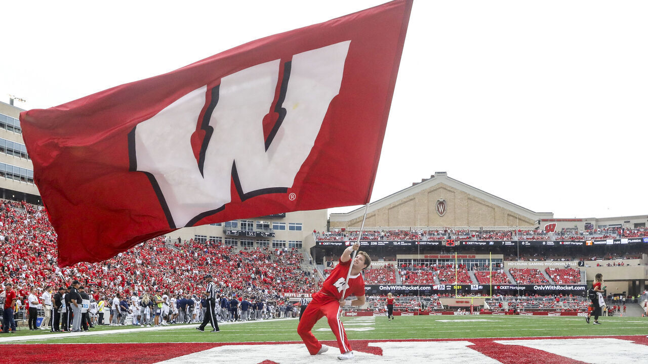MADISON, WI - SEPTEMBER 16: Wisconsin cheerleader waves the Wisconsin fan following a touchdown during a college football game between the University of Wisconsin Badgers and the Georgia Southern University Eagles on September 16, 2023, at Camp Randall Stadium in Madison, WI.