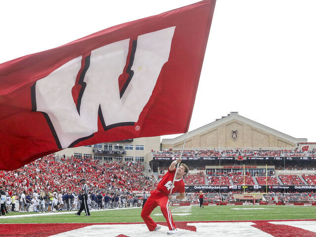 MADISON, WI - SEPTEMBER 16: Wisconsin cheerleader waves the Wisconsin fan following a touchdown during a college football game between the University of Wisconsin Badgers and the Georgia Southern University Eagles on September 16, 2023, at Camp Randall Stadium in Madison, WI.