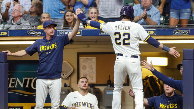 MILWAUKEE, WI - AUGUST 07: Milwaukee Brewers left fielder Christian Yelich (22) high-fives manager Craig Counsell (30), left, after scoring a run in the fourth inning during a regular season game between the Colorado Rockies and Milwaukee Brewers on August 07, 2023 at American Family Field in Milwaukee, WI.
