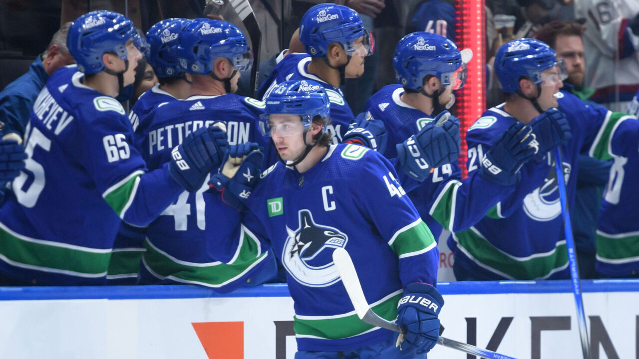 VANCOUVER, CANADA - OCTOBER 27: Quinn Hughes #43 of the Vancouver Canucks is congratulated at the players bench after scoring a goal against the St. Louis Blues during the second period of their NHL game at Rogers Arena on October 27, 2023 in Vancouver, British Columbia, Canada.