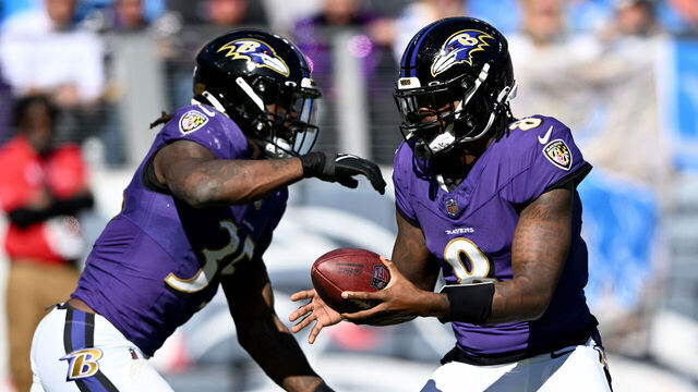 BALTIMORE, MARYLAND - OCTOBER 22: Lamar Jackson #8 of the Baltimore Ravens hands the ball to Gus Edwards #35 during the game against the Detroit Lions at M&T Bank Stadium on October 22, 2023 in Baltimore, Maryland.